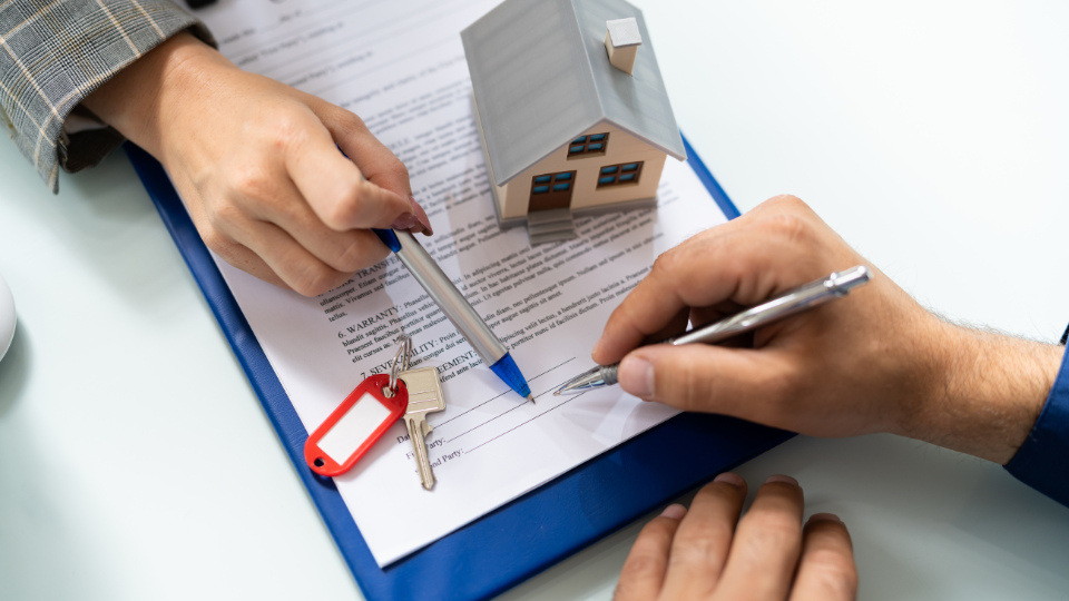 A lender and a borrower go over loan guidelines together. 