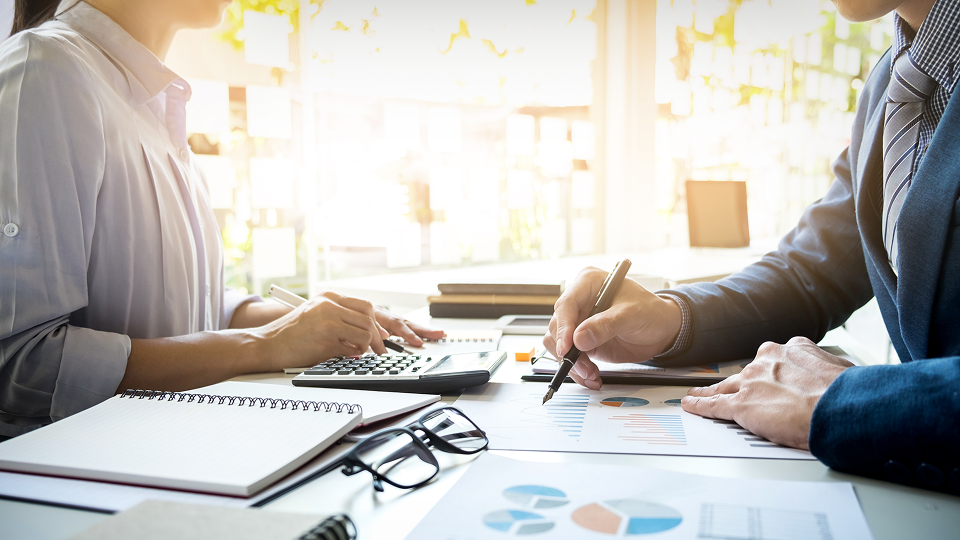An underwriter works with a potential lender, going through FHA compensating factors to help get them approved